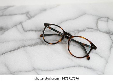 Tortoise Shell Glasses On Marble Background, Copy Text