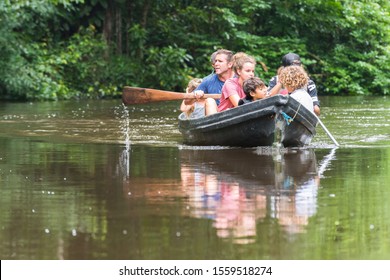 Tortuguero, Costa Rica - July 16, 2019: Family With Rowboat Exploring The Rio Tortuguero Forest. Ecotourism Concept.