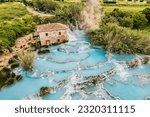 Toscane Italy, natural spa with waterfalls and hot springs at Saturnia thermal baths, Grosseto, Tuscany, Italy. Aerial view. Natural thermal waterfalls at Saturnia Toscany