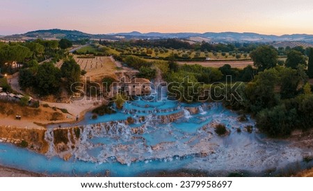 Toscane Italy, natural spa with waterfalls and hot springs at Saturnia thermal Baths, Grosseto, Tuscany, Italy aerial view on the Natural thermal waterfalls couple on vacation holiday inSaturnia