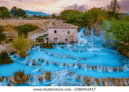 Toscane Italy, a natural spa with waterfalls and hot springs at Saturnia Thermal Baths, Tuscany, Italy. couple on vacation in Saturnia Tuscany visit Natural hot springs thermal waterfalls 