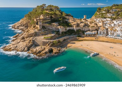 Tossa de Mar town on Costa Brava Mediterranean coast in Catalonia, Spain. Beautiful beach with turquoise color water and Tossa de Mar fortress during summer in Catalonia.