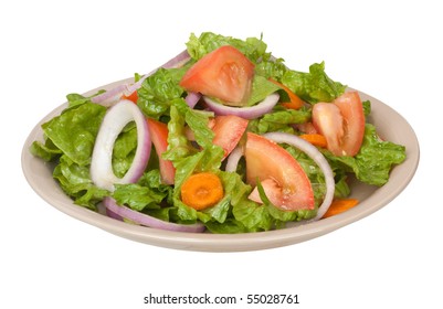 Tossed salad with lettuce, tomatoes, onions and carrots on a plate isolated on white