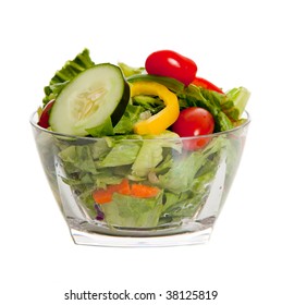A tossed salad with various vegetables on a white background