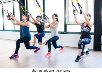 Total Body Resistance Exercise TRX Trainer Training Together Squat And Pull Up For Whole Body Muscle Workout.