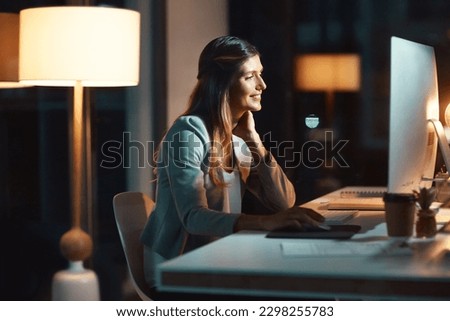 Total dedication at all hours. a young businesswoman using a computer during a late night at work.