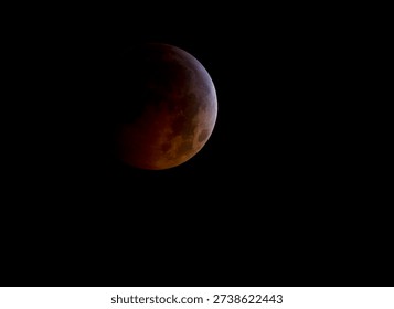 A total lunar eclipse is seen as the full moon is shadowed by the Earth on the arrival of the winter solstice, December 21, 2010 in Arlington, VA. Photo from outer space.