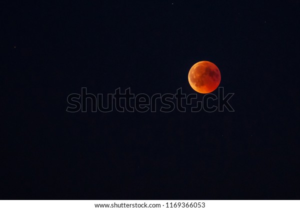 Total moon\
eclipse with blood moon in close\
up