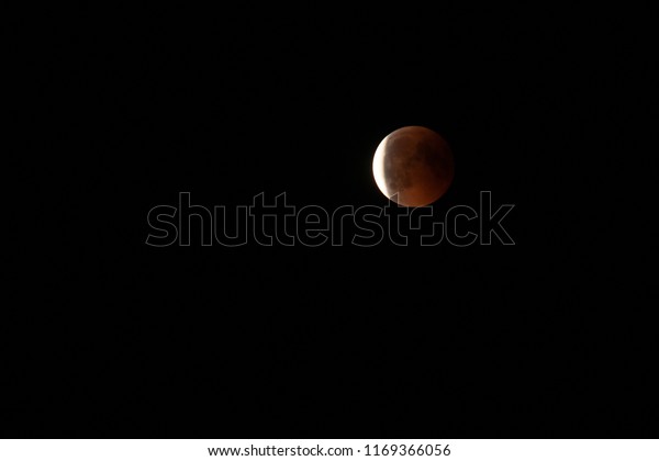 Total moon\
eclipse with blood moon in close\
up