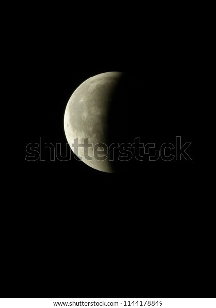 Total Moon eclipse, July 27-28, 2018,\
Athens. Three hours after the beginning of the eclipse, half of the\
Moon\'s disk has gone out of the Earth\'s\
shadow.