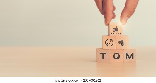 Total quality management (TQM) concept, Text and icon on wooden cubes with light background and copy space. A management approach to long-term success through customer satisfaction and sustainability. - Shutterstock ID 2007001262