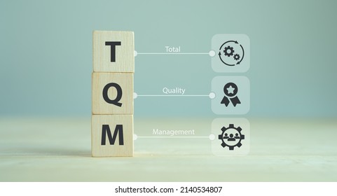 Total quality management (TQM) concept, TQM on wooden cubes with symbols on smart background, copy space. Management approach to long-term success through customer satisfaction and sustainability. - Shutterstock ID 2140534807