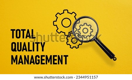 Total Quality Management TQM is shown using a text and photo of magnifying glass