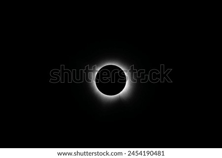 Total solar eclipse during totality near Mount Ida, Arkansas on April 8, 2024.  Solar prominences can be seen at the edge of the black moon with the corona emanating out