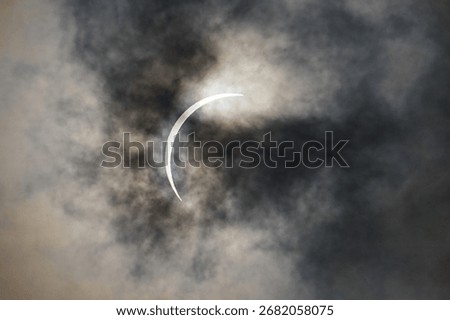 Total Solar Eclipse through swirling clouds and fog at Garner State Park Texas.  Great American Mexican Eclipse GAME 2024.  Red solar flares and prominances are abundant.