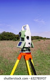 Total station. Survey Instrument geodetic device. Fall time land surveying, total station set in the field.