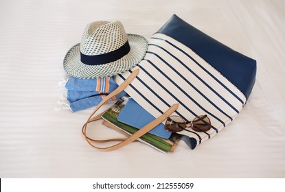 Tote Bag Full of Summer Beach Essentials , Hat, Towels, Sunglasses, Tablet - Powered by Shutterstock