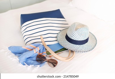 Tote Bag Full of Summer Beach Essentials , Hat, Towels, Sunglasses, Tablet - Powered by Shutterstock