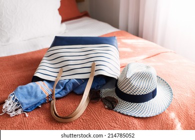 Tote Bag Full of Summer Beach Essentials , Hat, Towels, Sunglasses, Tablet - Powered by Shutterstock