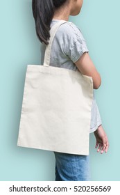 Tote Bag Mockup Cotton Canvas Fabric Texture On Girl Shoulder (clipping Path) In White Cream Color Isolated On Blue Background