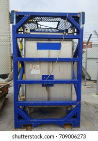 A Tote Tank At Open Yard Of Oil And Gas Warehouse. Tote Tank Are A Chemical Storage Bulk Tank. 