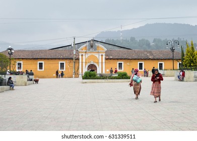 Totonicapan, Guatemala - February 10, 2015: Maya People Stroll The Main Square Of A Small Colonial Town Of Totonicapan In Guatemala. Central America. All Women Wear Traditional Maya Outfit