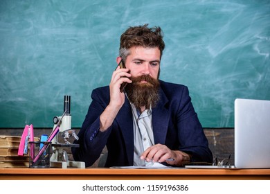 In Touch With School. School Principal Or Teacher Calling Parents To Report About Exam Results. Man With Beard Talk Phone Classroom Background. School Teacher Cares About Communication With Parents.