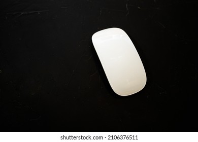 Touch White Computer Mouse On A Black Background