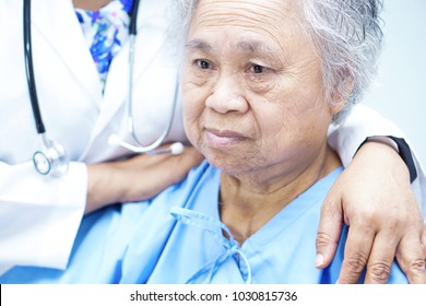Touching Asian senior or elderly old lady woman patient with love, care, encourage and empathy at nursing hospital : healthy strong medical concept 