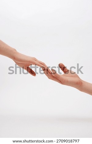 Touching hands show unity and connection in a simplistic, serene setting