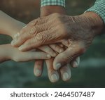 A touching image of three pairs of hands, representing different generations – grandfather, father, and son – intertwined in a gesture of familial love and support.Father