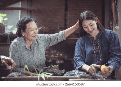 A touching scene featuring an elder and a young woman sharing laughter and joy as they prepare fruit together in a traditional setting, highlighting familial love.