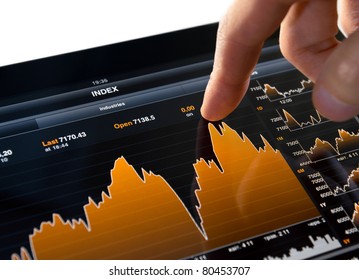 Touching stock market graph on a touch screen device. Trading on stock market concept. Closeup photo. - Powered by Shutterstock