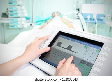 Touchpad in the hospital. The doctor adjusts the parameters of the patient