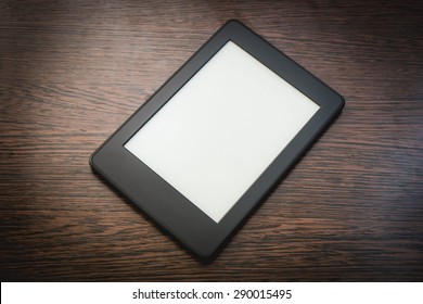 a touchscreen tablet for reading electronic book on the wooden background