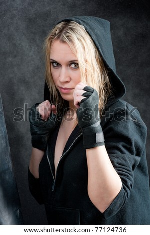 Similar – Close up front upper body portrait of one young athletic woman in sportswear in gym over dark background, looking at camera