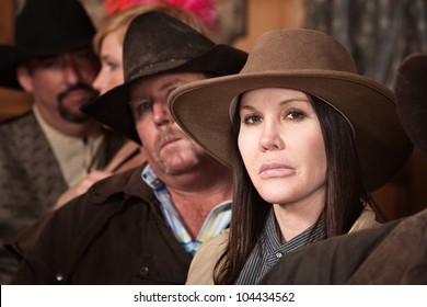 Tough Cowgirl Between People In Crowded Bar