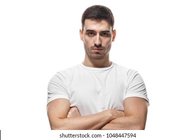 Tough Guy Standing With Crossed Arms Isolated On White Background. Serious Young Man Portrait Concept