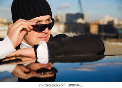 Tough Guy In White Sweater Jacket Near His Car