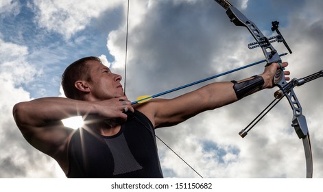 Tough Man With Bow And Arrows, Close Up With Cloudy Sky At Background