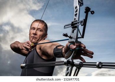 Tough Man With Bow And Arrows, Close Up With Cloudy Sky At Background