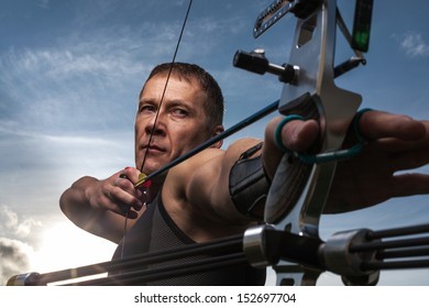 Tough Man With Bow And Arrows, Close Up With Cloudy Sky At Background