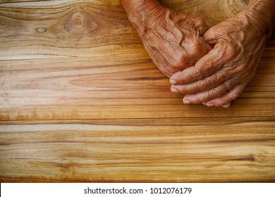 Tough, Poor, Disable Patient, Hands Of Old Woman Work Hard, Labor Worker  Pain For All Life Ages Person, Isolated Elder Sad Mother Wrinkle Hand Wooden Background, Asian People Tough Life Concept