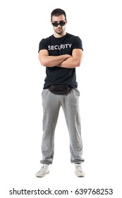 Tough Serious Bouncer Or Bodyguard With Crossed Arms Staring At Camera. Full Body Length Portrait Isolated On White Studio Background. 