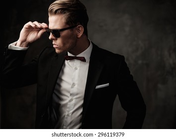 Tough sharp dressed man in black suit 
