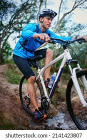 Tough Terrain For A Tough Man. Shot Of A Male Cyclist Riding Along A Mountain Bike Trail.