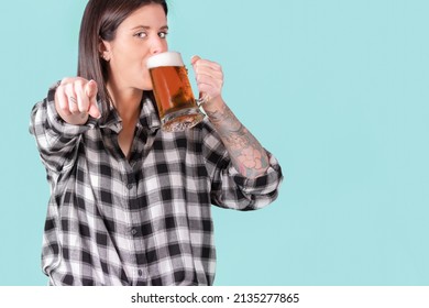 Tough Woman With Tattooed Arm Drinking A Mug Of Beer