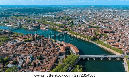 Toulouse city and Garonne river aerial panoramic view. It's the capital of southern France Occitanie region. Historical landmark Dome de La Grave from above in Haute Garonne on a summer day 5.5K UHD