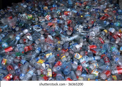 TOULOUSE, FRANCE - CIRCA 2009: Clear plastic bottles lie in a heap at an undisclosed recycling facility circa 2009 in Toulouse. The plastic is gathered by color and type to be recycled.