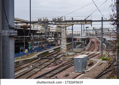Toulouse, France - Dec. 2019 - Detail of overhead lines and industrial railway landscape in Matabiau train station, with platforms, electric pylons and railroad switches (turnouts) on the tracks